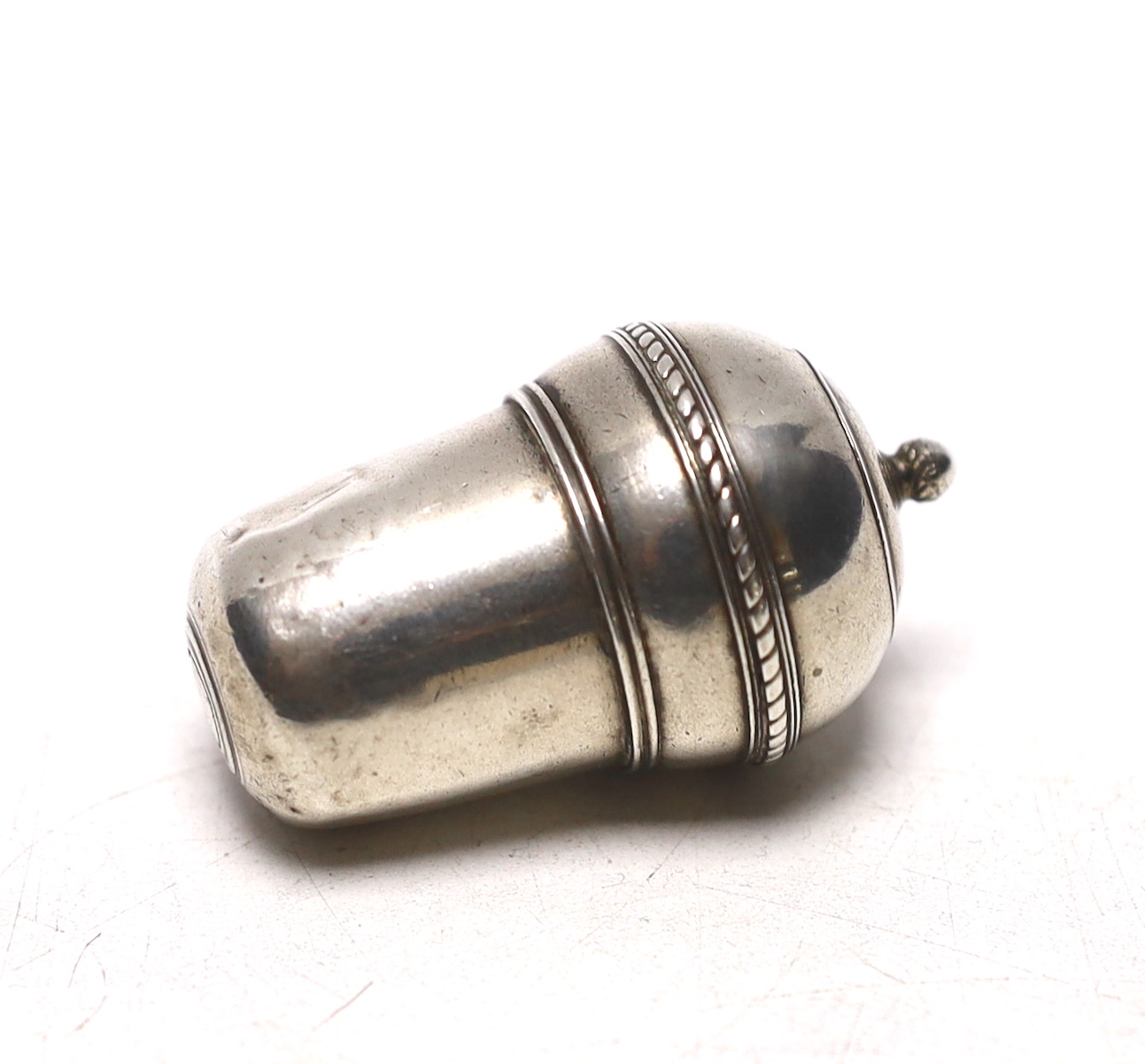 A continental white metal nutmeg grater?, modelled as an acorn, lacking rasp, makers mark to lid interior, 50mm.